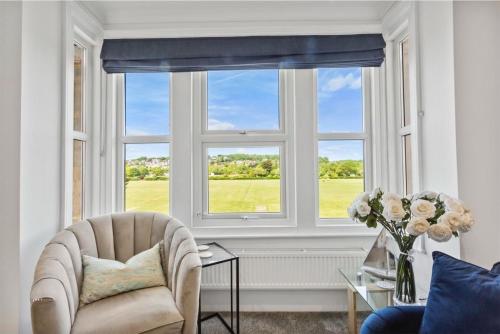 a living room with a chair and a large window at Ahoy There! in Hythe