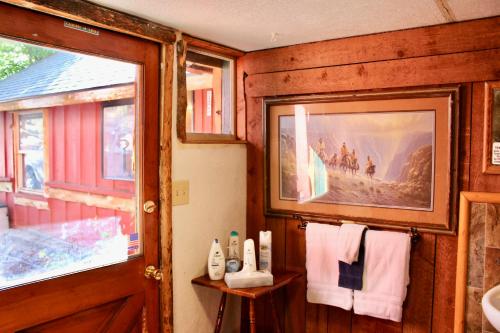 a bathroom with towels and a sink and a window at Boulder Bay Cottages in Big Bear Lake