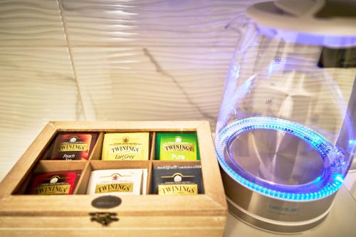 a wooden box with a jar of milk next to a blender at La Maison Apparthotel in Praia a Mare