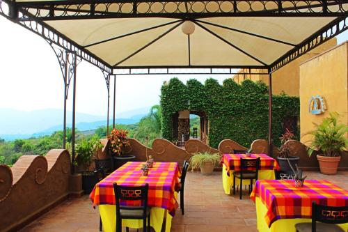 a restaurant with tables and chairs with a view at Wellness Center El Secreto in Tepoztlán