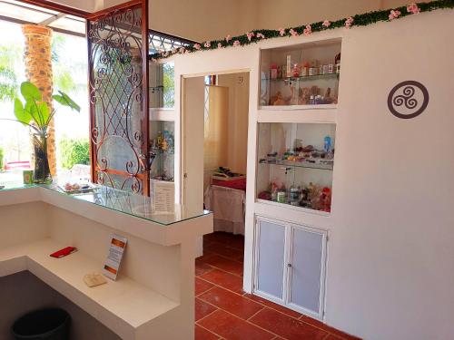 a room with a glass display case in a room at Wellness Center El Secreto in Tepoztlán