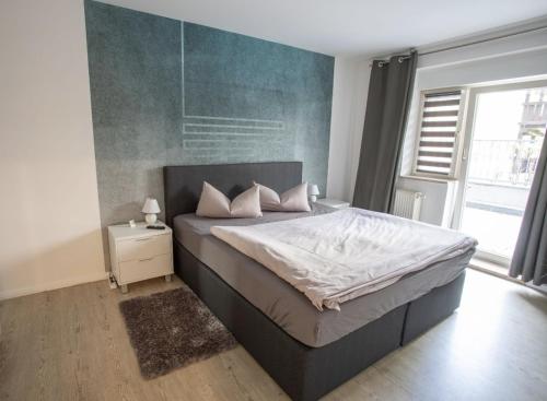 a bedroom with a large bed and a large window at Ottostadt in Magdeburg