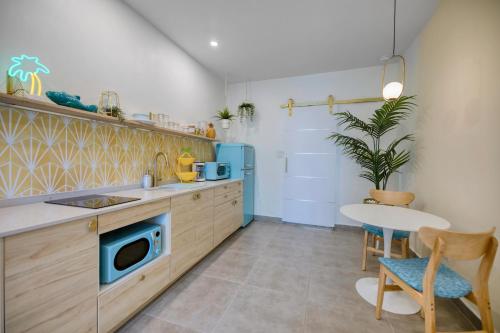 a kitchen with a sink and a table at HOUS - Ocean Park - Pool - Sunset Lounge in San Juan