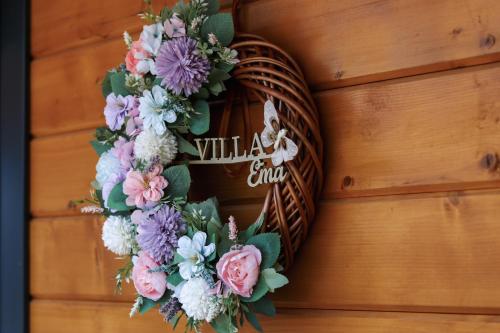 a wreath on a door with flowers on it at Villa Ema in Pale