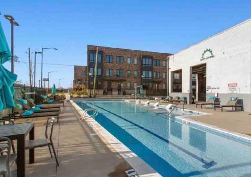 a swimming pool with chairs and tables and a building at Atlanta Cozy Loft Apartment in Atlanta