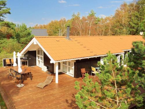 an overhead view of a house with a wooden deck at 8 person holiday home in L s in Læsø