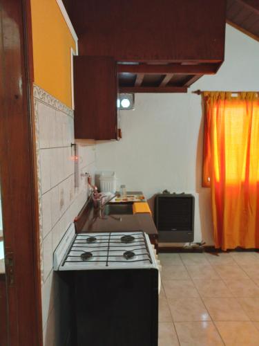 a kitchen with a stove top oven in a room at Cabañas Monik in El Calafate