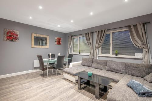 a living room with a couch and a table at SEASIDE SPACIOUS apartment in Peterlee