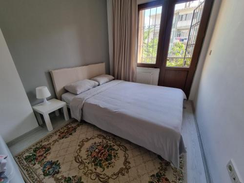 a small bedroom with a bed and a window at Maltepe, Cevizli cozy apt in Istanbul