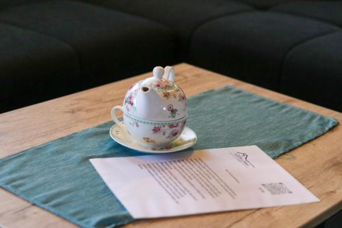 a tea cup with bunny ears sitting on a table at Villa Ema in Pale