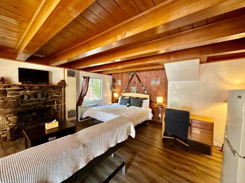 a bedroom with a large bed and a fireplace at Boulder Bay Cottages in Big Bear Lake