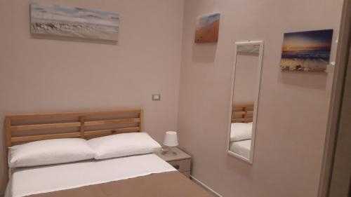 מיטה או מיטות בחדר ב-La Dimora di Dora
