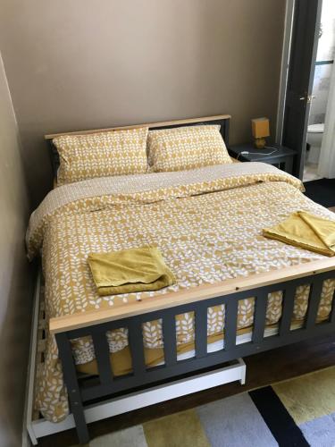 a bed with two yellow pillows in a bedroom at Stonyhurst in Chorley