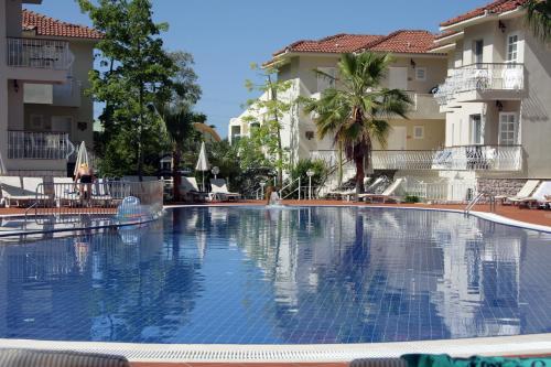 a large swimming pool in front of two buildings at The Blue Lagoon Deluxe Hotel in Oludeniz