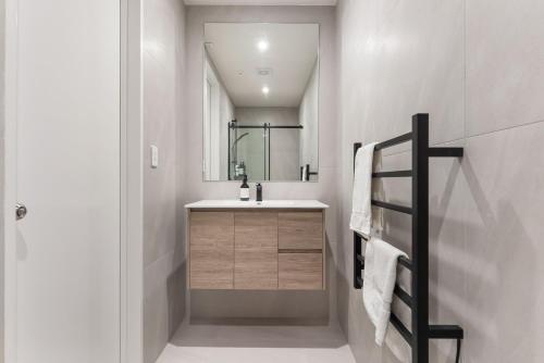 a bathroom with a sink and a mirror at 302 The Residence in Auckland