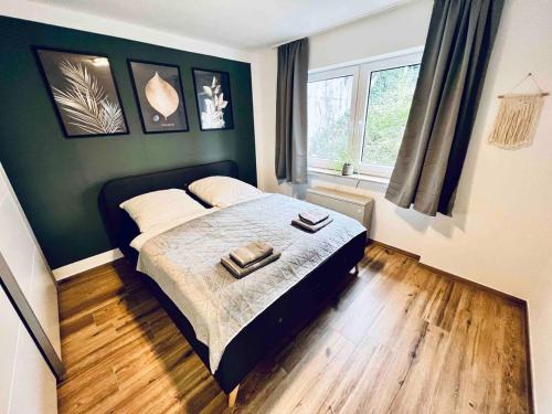 a bedroom with a bed with two towels on it at Auszeit Niedersfeld in Winterberg