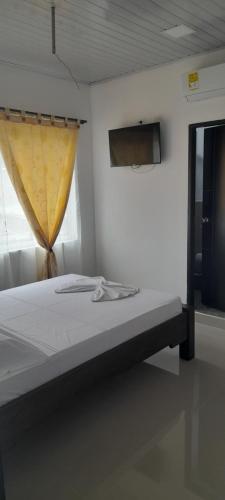 Postel nebo postele na pokoji v ubytování Hotel Apartado Real