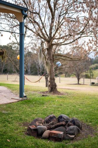 a pile of rocks in the grass in a park at Barrington Riverside Cottages in Barrington