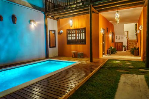 a swimming pool in the middle of a house at Pousada Casa Joana Trancoso in Trancoso