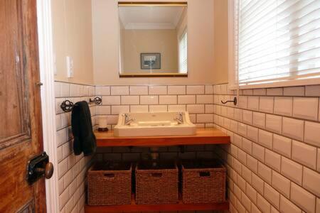 a bathroom with a sink and a mirror at Kosbys Cottage, Tongariro 