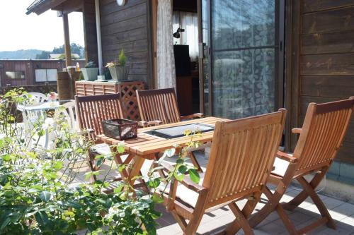 a wooden table and chairs on a patio at Log house Tomi-chan's house / Private building in Echizen
