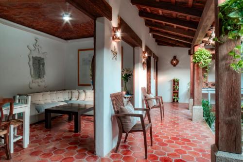 a living room with a table and chairs at Casa Hacienda in Sayulita