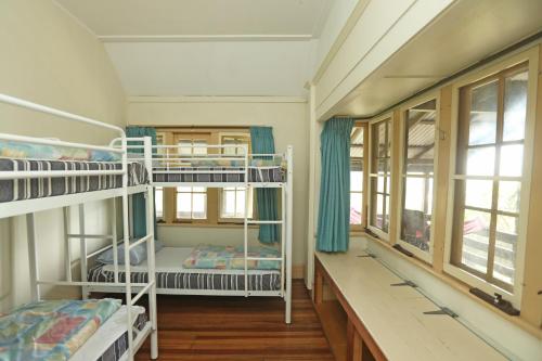 a room with two bunk beds and a window at YHA Pittwater Eco, Sydney in Church Point