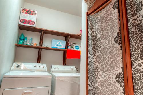 a small laundry room with a washer and dryer at Casa Hacienda in Sayulita