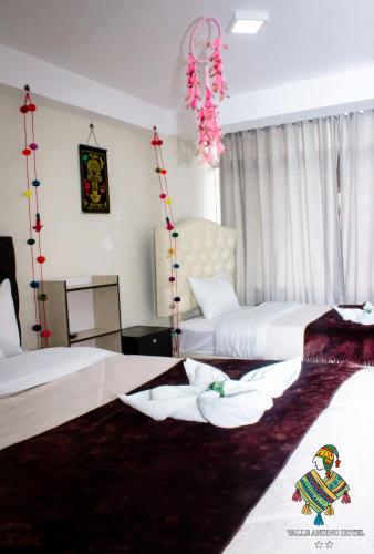a hotel room with two beds with pink decorations at Hotel Valle Andino in Cusco