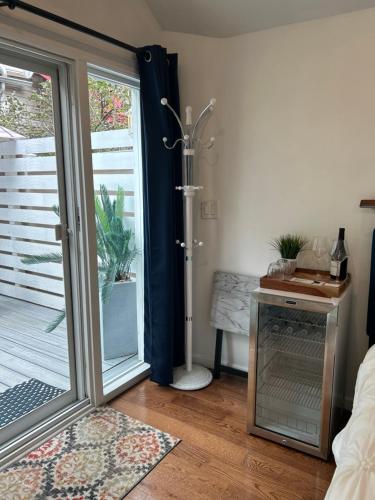 a bathroom with a shower and a sliding glass door at Adorable 1 bedroom cottage in Forest Hills