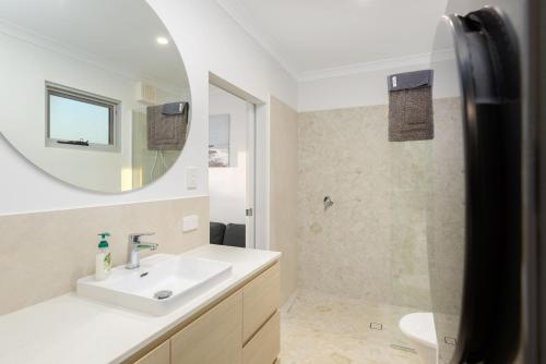 a bathroom with a sink and a mirror at 22 Cooyou Close in Exmouth