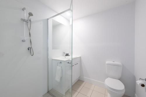 a white bathroom with a shower and a toilet at Boulevard North Lakes in North Lakes