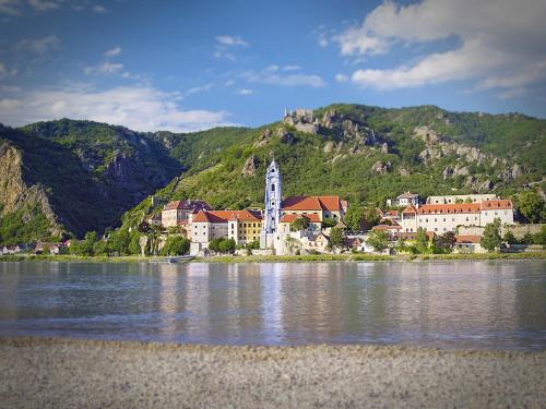 a small town on the shore of a body of water at Gartenhotel & Weingut Pfeffel Dürnstein in Dürnstein