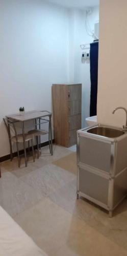a kitchen with a sink and a table at SEACOAST HOTEL AND RESORTS in Mactan