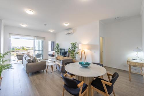 a living room with a table and chairs at Boulevard North Lakes in North Lakes