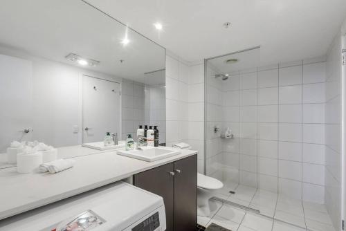 a bathroom with a sink and a toilet and a shower at Digital Nomad Dreaming across from Albert Park in Melbourne