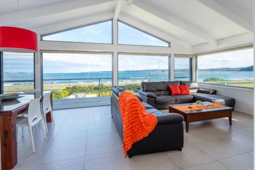 a living room with a couch and a table at Beachside Long Beach in Long Beach