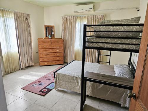 a bedroom with a bunk bed and a dresser at The Green Palms Getaway, Palmiste, San Fernando - 6 BR 4 Bath 12 guests 