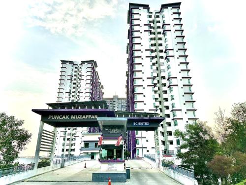 a large white building with two tall buildings at Nureenas Residence Condominium in Ayer Keroh