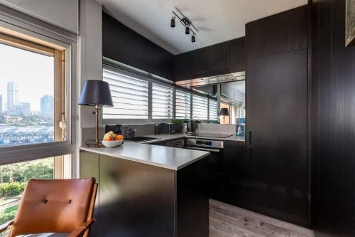 a kitchen with dark brown cabinets and a window at Best Sydney Views from Potts Point with Rooftop Pool in Sydney
