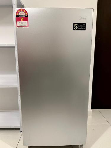 a silver refrigerator with a sign on the side of it at Nureenas Residence Condominium in Ayer Keroh