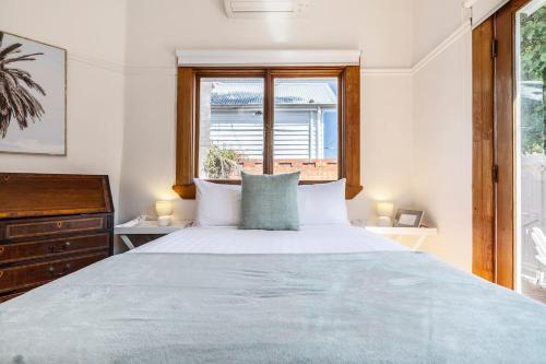 a bedroom with a large bed and a window at 'The Georgian' Classic Comfort in St Kilda's Heart in Melbourne