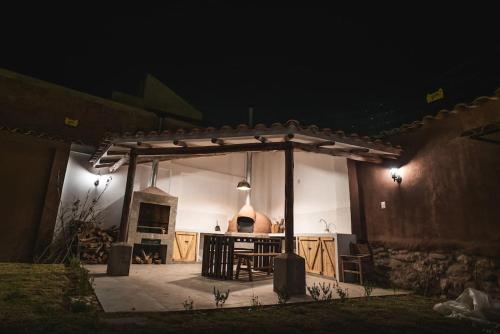 a pavilion with a table in front of a house at night at Beautiful house in the Sacred Valley "Casa Julia Cusco" in Cusco