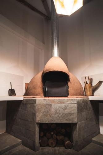 a stone fireplace with a bag on top of it at Beautiful house in the Sacred Valley "Casa Julia Cusco" in Cusco
