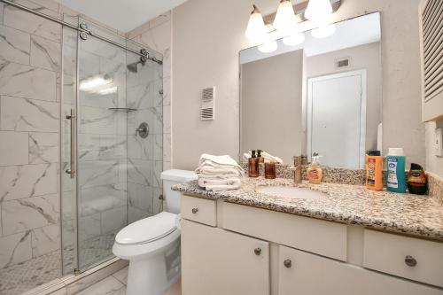 a bathroom with a shower and a toilet and a sink at Tranquil 3BR Getaway:Modern in Houston