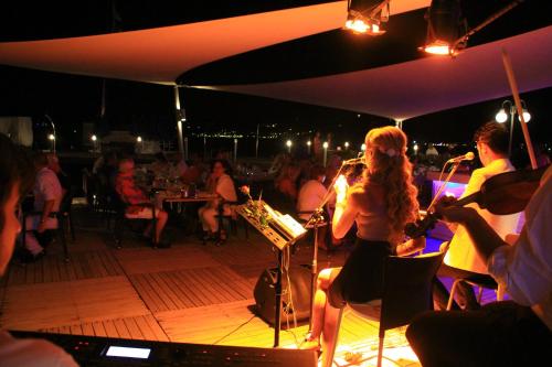 a group of people playing music on a stage at Torbahan Hotel in Torba