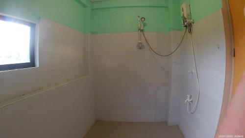 a bathroom with a shower and a window at LaVeranda Beach Resort in Dauis