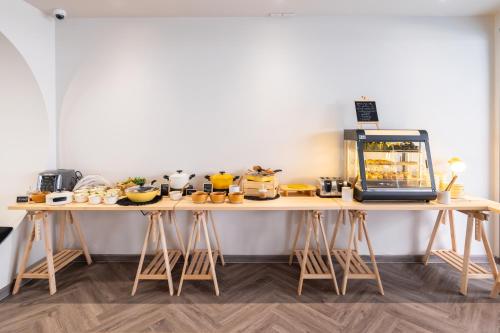 a table with several different types of shoes on it at Blu Monkey Hub and Hotel Krabi Town in Krabi town