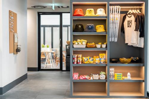a room with a shelf filled with shoes at Blu Monkey Hub and Hotel Krabi Town in Krabi town