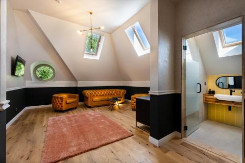 a attic bathroom with a sink and a toilet at Boutique Hotel Cocosul de Aur in Târgu-Mureş
